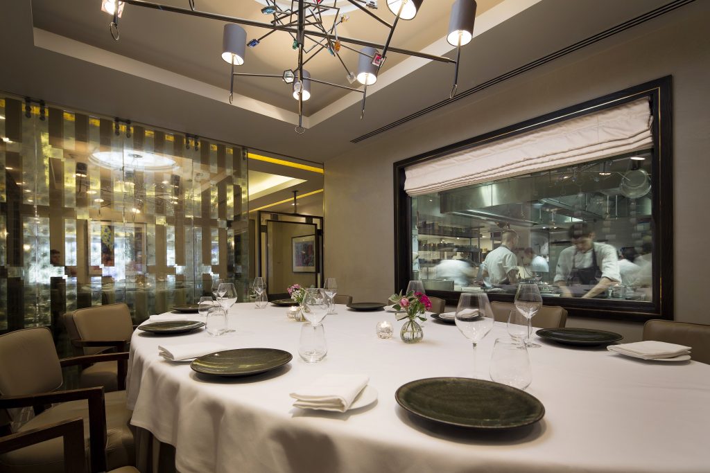 Murano By Angela Hartnett Private Dining Room Image View Of Chefs In Kitchen Through Glass Window